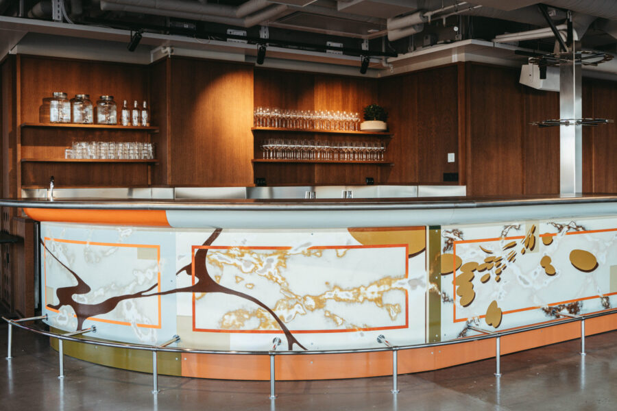 Long arched bar counter against a dark wooden wall